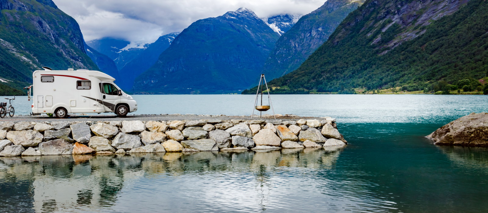 Couple sitting together on couch looking at laptop