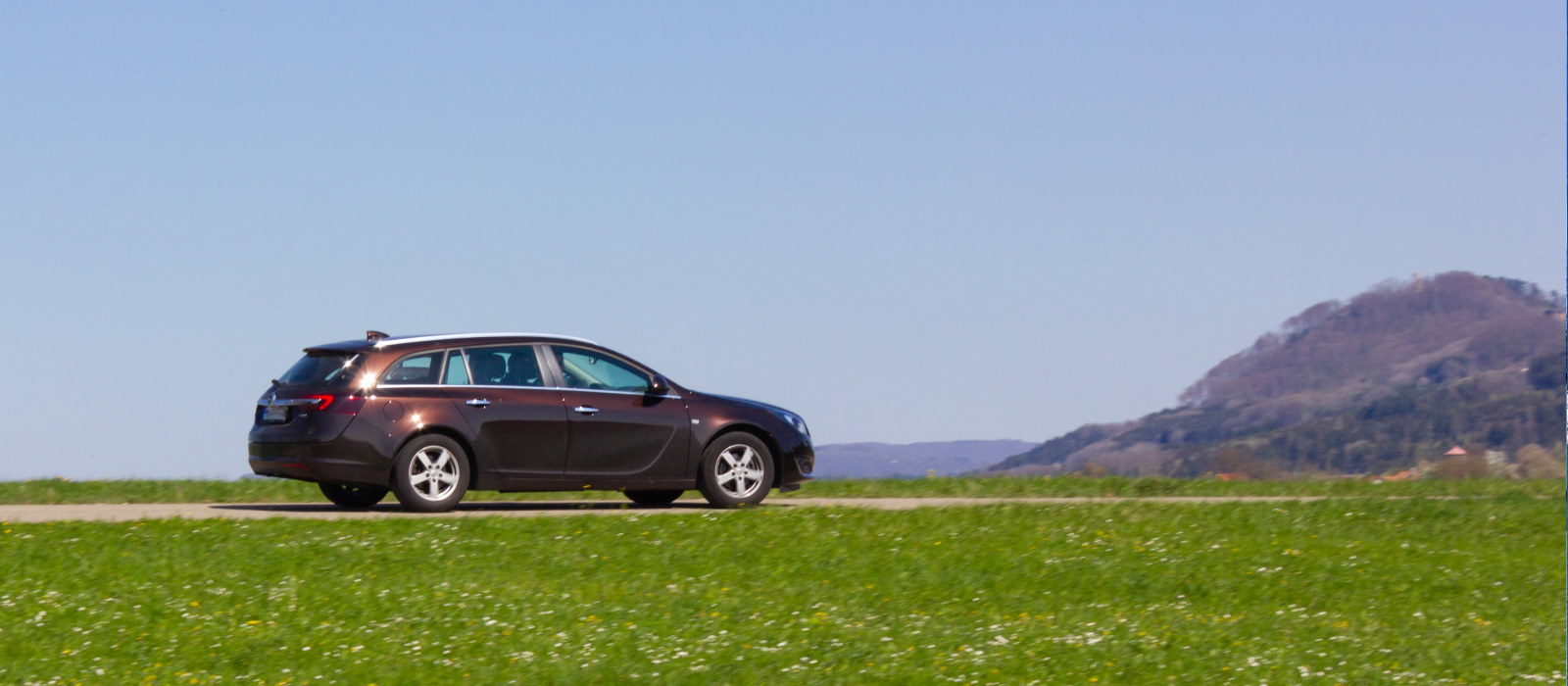 Couple sitting together on couch looking at laptop